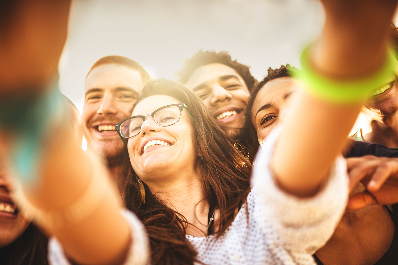 Teens taking selfie with iPhone